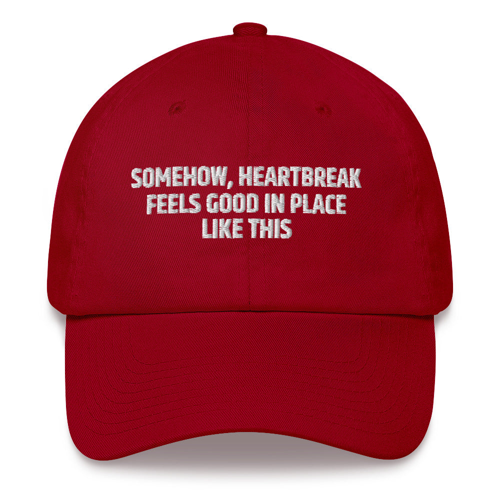 Somehow Heartbreak Feels Good In A Place Like This  hat