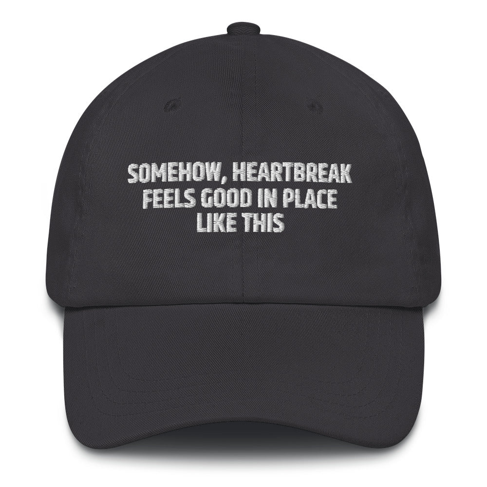 Somehow Heartbreak Feels Good In A Place Like This  hat