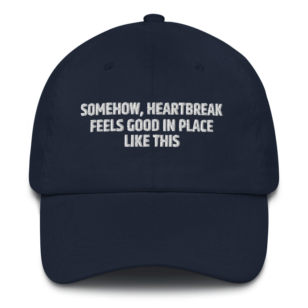 Somehow Heartbreak Feels Good In A Place Like This  hat