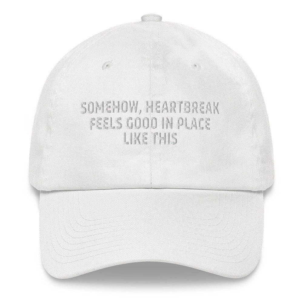 Somehow Heartbreak Feels Good In A Place Like This  hat